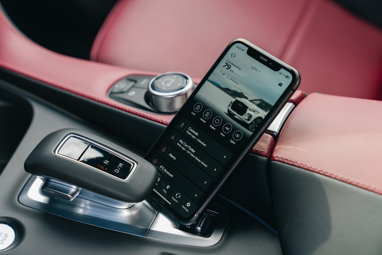 creative Close-up of smartphone with car control app in a luxury car's interior, showcasing modern technology.